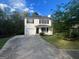 Exterior of home with lush landscaping, a driveway, and large shuttered windows at 194 Bay Court Dr, Stockbridge, GA 30281