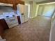 Kitchen featuring tile flooring, wood cabinets, and white appliances at 194 Bay Court Dr, Stockbridge, GA 30281