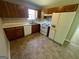 Kitchen featuring wood cabinets, white appliances, and tile flooring for easy maintenance at 194 Bay Court Dr, Stockbridge, GA 30281