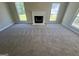 Bright living room with neutral carpet, fireplace, and large windows, creating a cozy atmosphere at 194 Bay Court Dr, Stockbridge, GA 30281