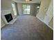 Well-lit living room featuring a fireplace, carpet, and multiple windows, offering ample space at 194 Bay Court Dr, Stockbridge, GA 30281