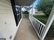 View of the covered front porch with a white railing and concrete floor at 194 Bay Court Dr, Stockbridge, GA 30281