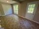 Bright room with large windows, access door, and closet space with tile flooring at 194 Bay Court Dr, Stockbridge, GA 30281