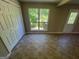 Bright room with large windows, access door, and closet space with tile flooring at 194 Bay Court Dr, Stockbridge, GA 30281