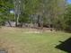 Large, expansive backyard with retaining wall and picnic table is perfect for Gathering activities at 1201 Turtle Creek Ct, Lawrenceville, GA 30043