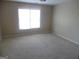 Bright carpeted bedroom with a large window allowing plenty of natural light at 1201 Turtle Creek Ct, Lawrenceville, GA 30043
