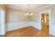 Traditional dining room boasts hardwood floors, chandelier and wainscoting at 1201 Turtle Creek Ct, Lawrenceville, GA 30043