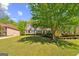 Lovely brick home featuring a large lawn and a mature tree providing ample shade at 1201 Turtle Creek Ct, Lawrenceville, GA 30043