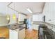 Open kitchen with white cabinets, dark granite countertops and stainless steel appliances at 1201 Turtle Creek Ct, Lawrenceville, GA 30043