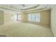 Large main bedroom with tray ceiling, carpet and multiple windows for natural light at 1201 Turtle Creek Ct, Lawrenceville, GA 30043