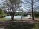 Scenic pond view with a fountain and picnic tables, creating a relaxing outdoor space at 1201 Turtle Creek Ct, Lawrenceville, GA 30043