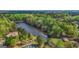 Scenic aerial view of a tranquil lake enveloped by lush trees and elegant homes at 229 Primstone Way, Mcdonough, GA 30253