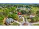 Residential aerial view of a landscaped property with mature trees, circular driveway, and lush landscaping at 229 Primstone Way, Mcdonough, GA 30253