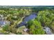 Gorgeous aerial view of a lake surrounded by lush trees, landscaping, and large homes at 229 Primstone Way, Mcdonough, GA 30253