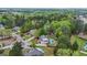 Aerial view of a home nestled in a neighborhood with lush green trees and winding roads at 229 Primstone Way, Mcdonough, GA 30253