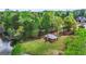Beautiful aerial view of lakeside gazebo surrounded by lush trees and landscaping at 229 Primstone Way, Mcdonough, GA 30253