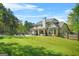 Expansive backyard featuring a well-manicured lawn, pool, and covered patio for outdoor entertaining at 229 Primstone Way, Mcdonough, GA 30253