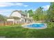 Spacious backyard featuring a sparkling blue swimming pool and mature trees at 229 Primstone Way, Mcdonough, GA 30253