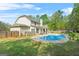 Spacious backyard featuring a sparkling blue swimming pool and mature trees at 229 Primstone Way, Mcdonough, GA 30253
