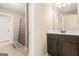 Bathroom featuring a vanity with dark wood cabinets, a shower with patterned curtain at 229 Primstone Way, Mcdonough, GA 30253