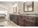 A bathroom with granite countertops, double sinks, tile floor and custom cabinets at 229 Primstone Way, Mcdonough, GA 30253