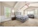 A primary bedroom with vaulted ceilings, ceiling fan, many windows for natural light, and sitting area at 229 Primstone Way, Mcdonough, GA 30253