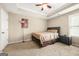This bedroom features a tray ceiling, carpeted floors, and a comfortable queen-size bed at 229 Primstone Way, Mcdonough, GA 30253