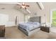 A primary bedroom with vaulted ceilings, ceiling fan, many windows for natural light at 229 Primstone Way, Mcdonough, GA 30253