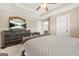 The main bedroom includes a ceiling fan, a large dresser with TV, and a walk-in closet at 229 Primstone Way, Mcdonough, GA 30253