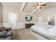 A primary bedroom with vaulted ceilings, ceiling fan, television, and sitting area at 229 Primstone Way, Mcdonough, GA 30253