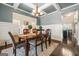 Elegant dining room featuring coffered ceiling, wainscoting, and stylish chandelier at 229 Primstone Way, Mcdonough, GA 30253