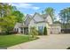 Well-maintained two-story home with lush lawn, featuring a three-car garage and neatly landscaped greenery at 229 Primstone Way, Mcdonough, GA 30253