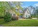 Charming two-story home featuring a manicured lawn, stone accents, and a welcoming front porch with blue rocking chairs at 229 Primstone Way, Mcdonough, GA 30253