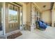 Cozy front porch with brick accents and blue rocking chairs creates a welcoming entrance at 229 Primstone Way, Mcdonough, GA 30253