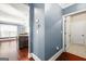 Hallway view with hardwood floors leading to the kitchen and an entrance to a bedroom at 229 Primstone Way, Mcdonough, GA 30253