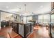 Spacious kitchen featuring a granite island, stainless appliances, and an open layout to the living room at 229 Primstone Way, Mcdonough, GA 30253