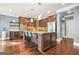Modern kitchen with a center island, stainless steel appliances, and dark wood cabinets at 229 Primstone Way, Mcdonough, GA 30253