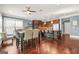 Eat-in kitchen featuring modern appliances, granite countertops, dark cabinetry and hardwood flooring at 229 Primstone Way, Mcdonough, GA 30253