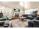 Spacious living room featuring a cozy fireplace, large windows, and an open floor plan at 229 Primstone Way, Mcdonough, GA 30253