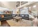 Open-concept living area with high ceilings, a large sofa, and elegant hardwood flooring at 229 Primstone Way, Mcdonough, GA 30253
