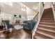 A spacious living room with fireplace, many windows for natural light, and staircase to the second level at 229 Primstone Way, Mcdonough, GA 30253