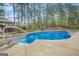 Inviting backyard pool featuring a well-maintained concrete deck and lush landscaping at 229 Primstone Way, Mcdonough, GA 30253
