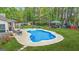 Beautiful backyard with a swimming pool, outdoor bar and grill, shed, and mature trees at 229 Primstone Way, Mcdonough, GA 30253