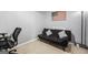 Comfortable room features a black futon with neutral walls and carpet perfect for an office or guest room at 229 Primstone Way, Mcdonough, GA 30253