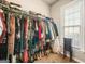 A walk-in closet filled with clothes and other accessories with a window at 229 Primstone Way, Mcdonough, GA 30253