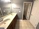 Bathroom with double vanity, large mirror, and walk-in closet at 4254 Wood Cove Dr, Snellville, GA 30039