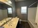 Bathroom featuring a shower-tub combo, dark vanity with modern sink, and updated fixtures at 4254 Wood Cove Dr, Snellville, GA 30039