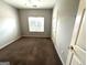 Bedroom with neutral walls, carpet, and a window at 4254 Wood Cove Dr, Snellville, GA 30039