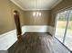 Charming dining room with chandelier, wainscoting, and access to the backyard at 4254 Wood Cove Dr, Snellville, GA 30039