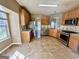 Well-lit kitchen features tile flooring, stainless steel appliances, and wooden cabinets at 4254 Wood Cove Dr, Snellville, GA 30039